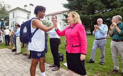  Susan Aldridge giving a high five to a student on campus